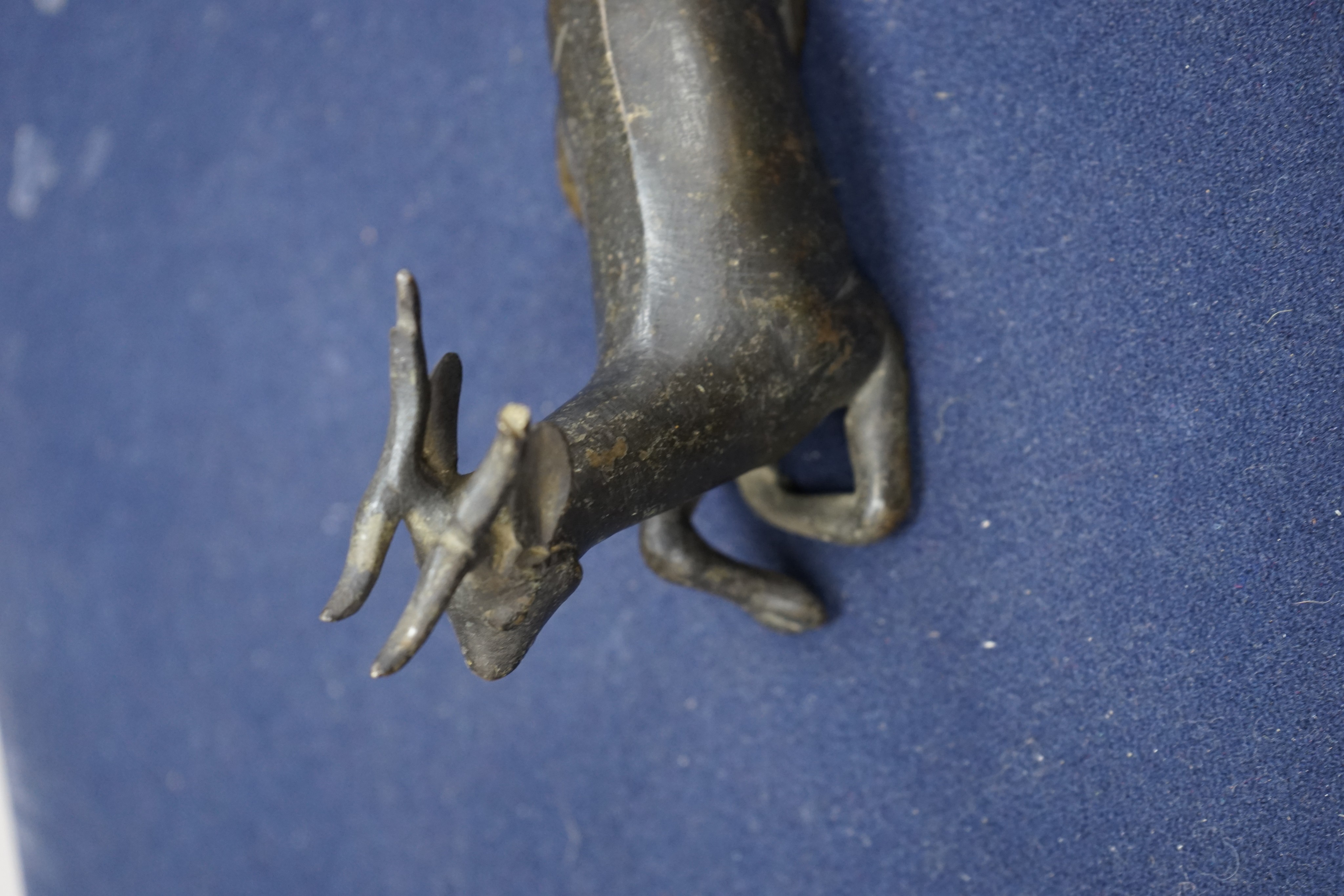 A Chinese early bronze figure of a deer, probably Yuan to Ming period, 13.5cm